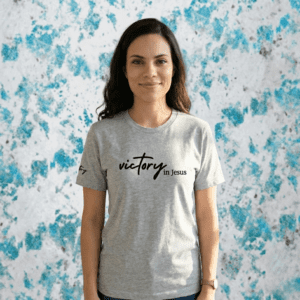 Woman wearing a shirt that says Victory in jesus